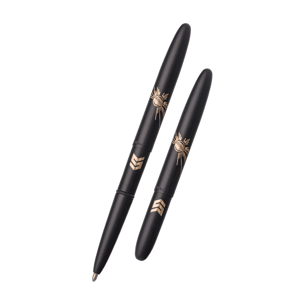 Left: Open matte black bullet space pen laser engraved with a solar burst and STEM logo
Right: Closed matte black bullet space pen laser engraved with a solar burst and STEM logo