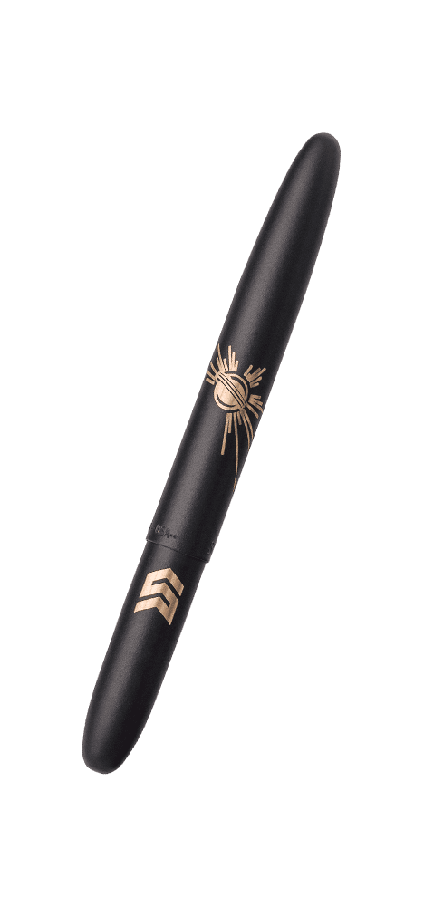 Closed matte black bullet space pen laser engraved with a solar burst and STEM logo